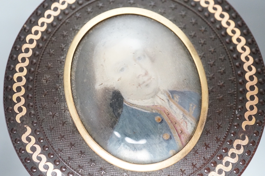 A 19th century pressed bois durci and gilt metal snuff box with painted miniature portrait of a gentleman on ivory to cover. 6cm diameter